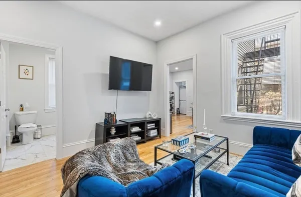 a living room with furniture and a flat screen tv