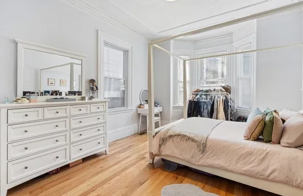 a bedroom with a bed and a dresser