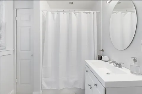 a bathroom with a sink vanity and a mirror