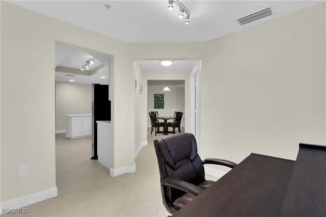 a view of a hallway with workspace and a couch