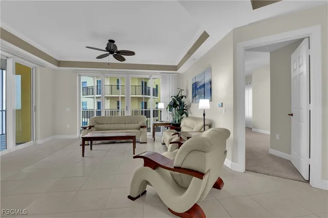 a living room with furniture a flat screen tv and a window