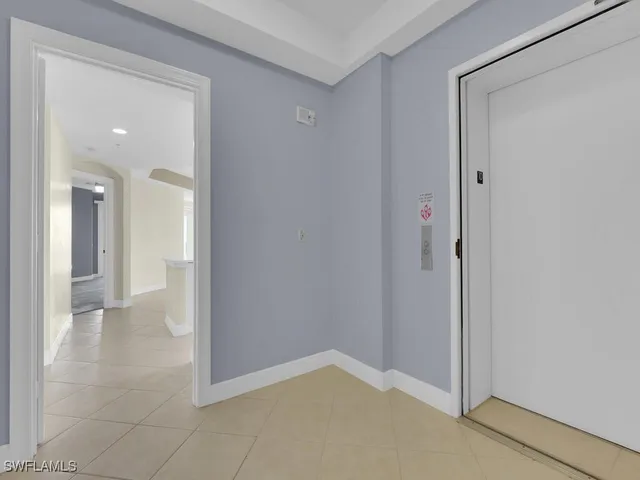 a view of an empty room and a bathroom