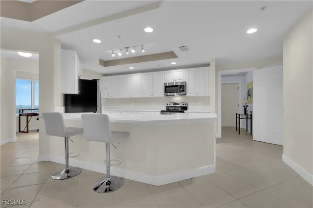 a view of kitchen with microwave and cabinets