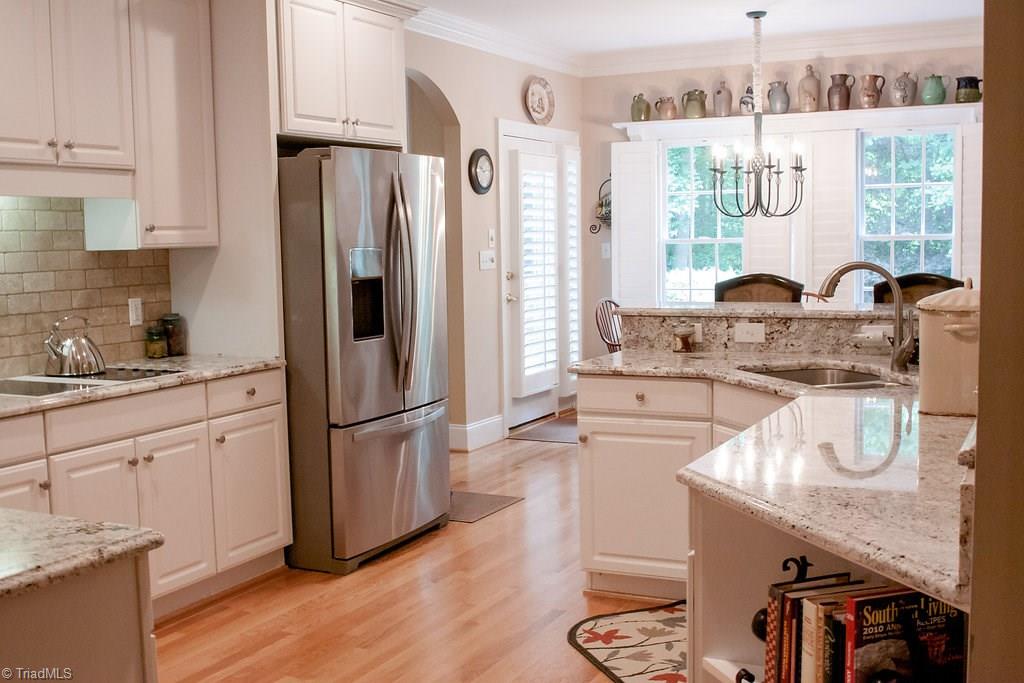 4109 Rockingham Road South Greensboro, NC 27407 - Photo 8 of 27 Cook's kitchen is complete with stainless appliances, designer granite and copious counter space/storage!