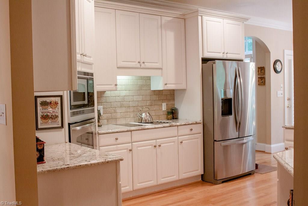 4109 Rockingham Road South Greensboro, NC 27407 - Photo 9 of 27 Closer view of backsplash and cooktop.