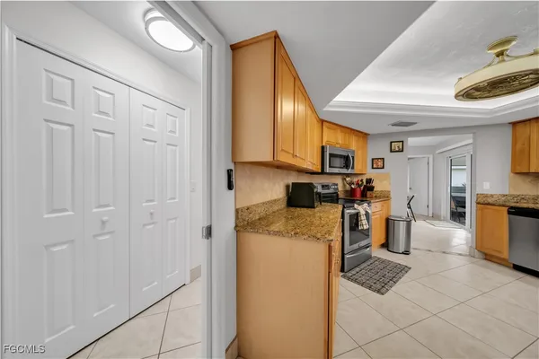 a kitchen with cabinets and refrigerator