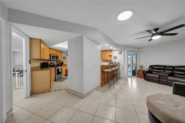 a view of kitchen with furniture and refrigerator