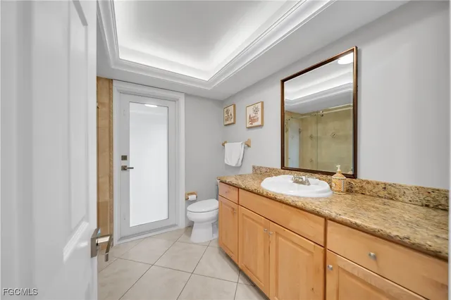 a spacious bathroom with a granite countertop sink and a mirror