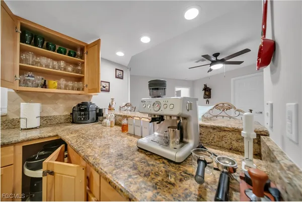 a living room with furniture and a kitchen