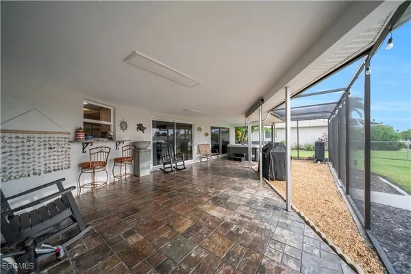 a view of a patio with a table and chairs under an umbrella