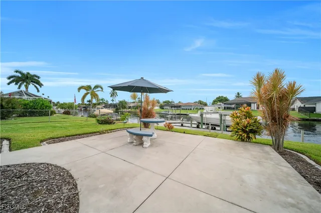 a view of a table and chairs under an umbrella