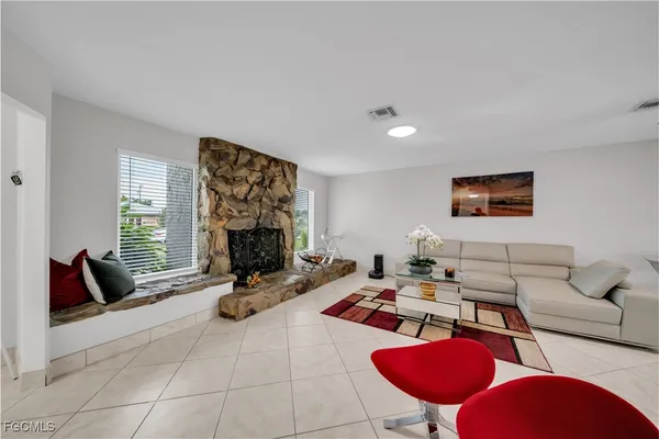 a living room with furniture a rug and a large window
