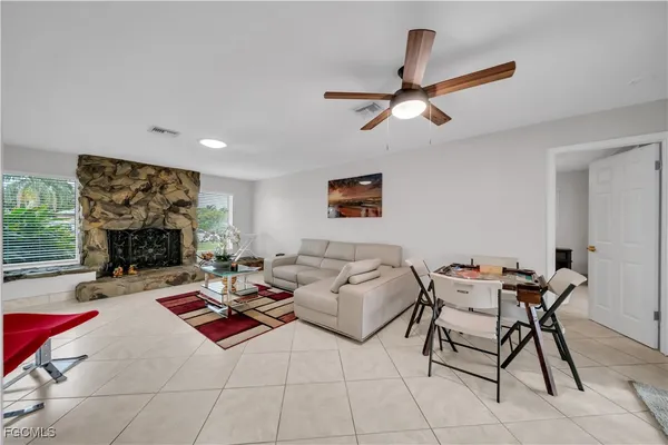 a living room with furniture a rug and a fireplace