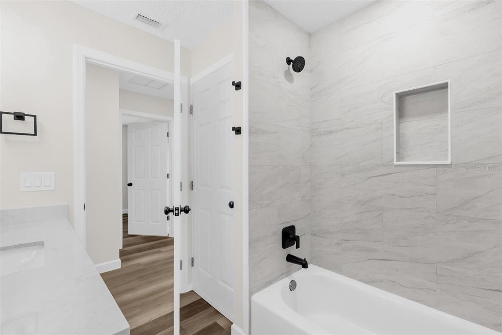 1507 Constantine Street Orlando, FL 32825 - Photo 15 of 27 a bathroom with a bathtub and shower