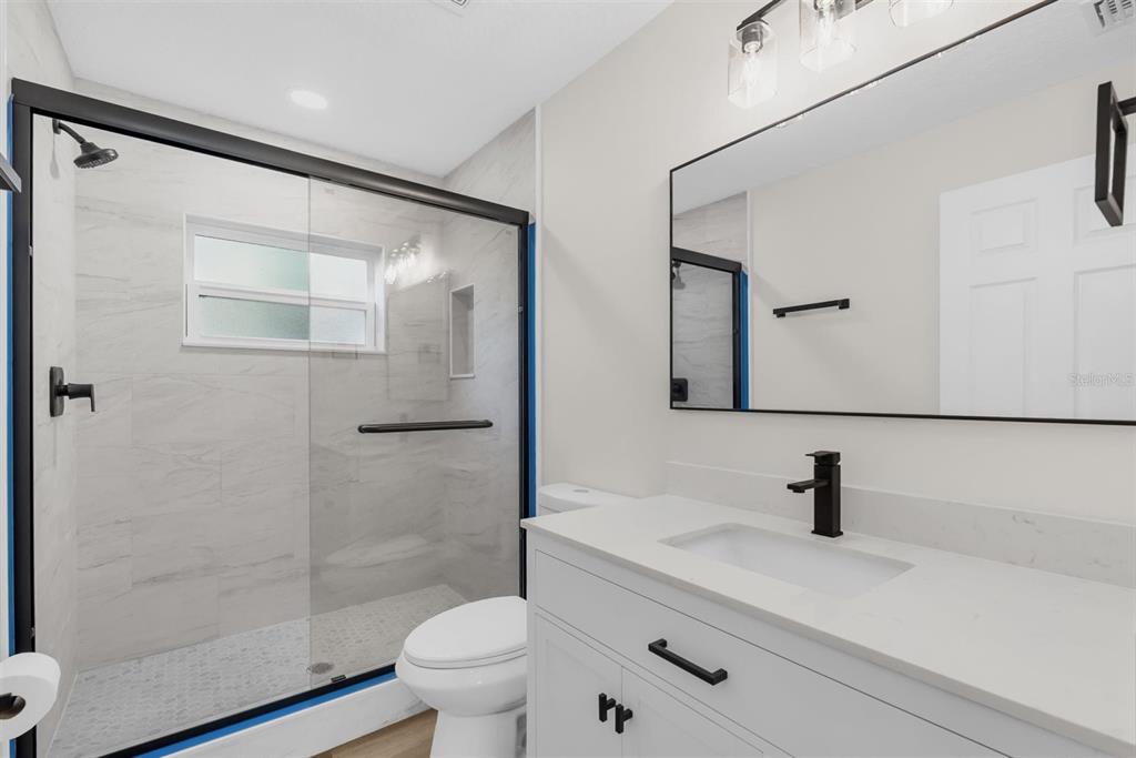 1507 Constantine Street Orlando, FL 32825 - Photo 19 of 27 a bathroom with a shower sink vanity and toilet