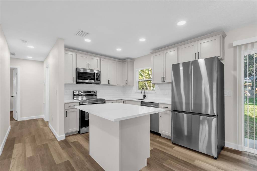 1507 Constantine Street Orlando, FL 32825 - Photo 2 of 27 a kitchen with stainless steel appliances a refrigerator stove microwave and sink