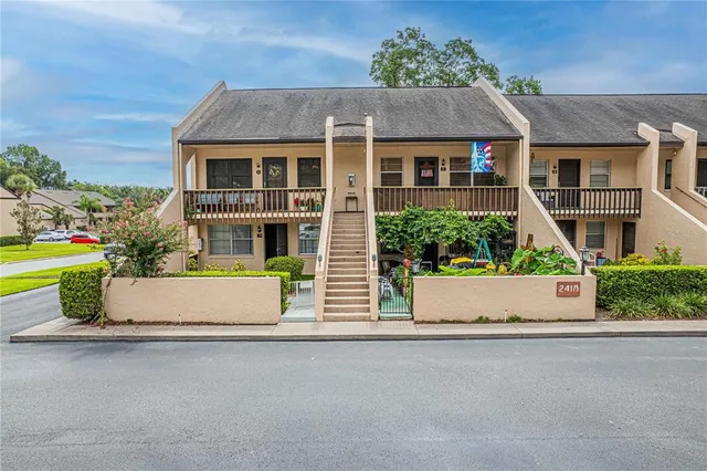 a front view of a house with a garden and plants