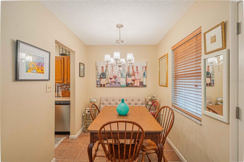 2418 Northeast 7th Street, Unit 6 Ocala, FL 34470 - Photo 11 of 39 a view of a dining room with furniture a chandelier and a window
