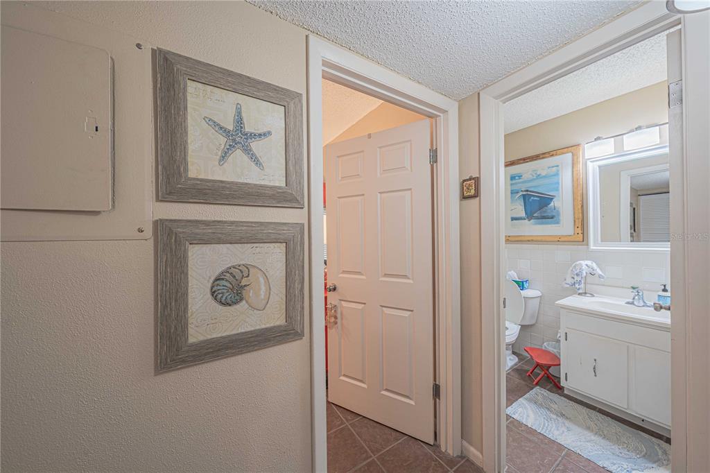 2418 Northeast 7th Street, Unit 6 Ocala, FL 34470 - Photo 12 of 33 a en suite bathroom with a sink mirror and a shower
