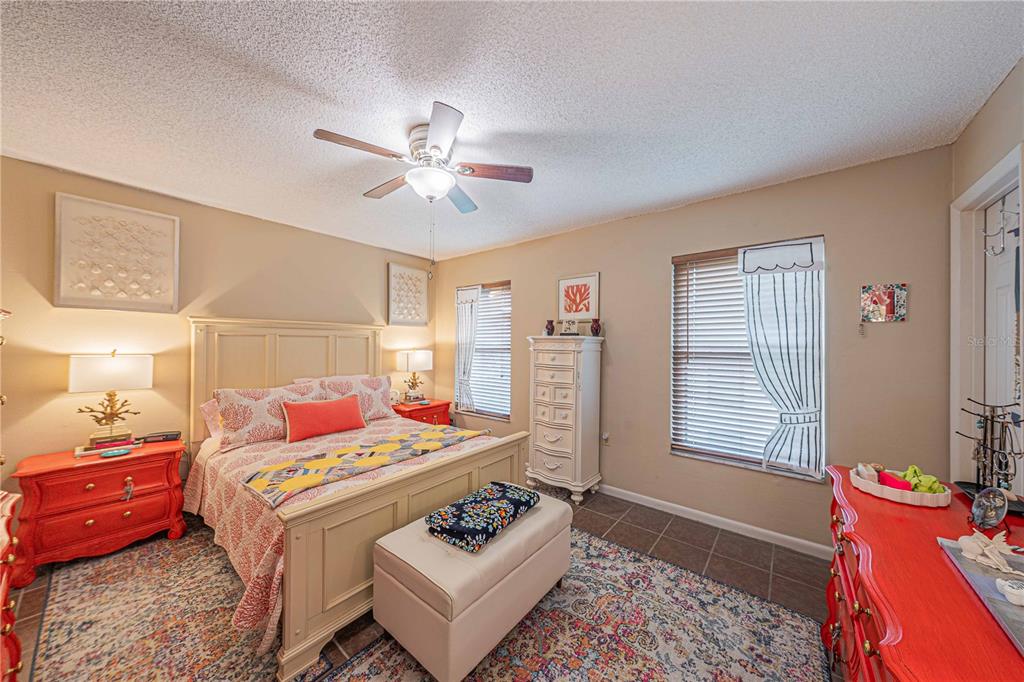 2418 Northeast 7th Street, Unit 6 Ocala, FL 34470 - Photo 16 of 33 a bedroom with a bed a couch and dresser