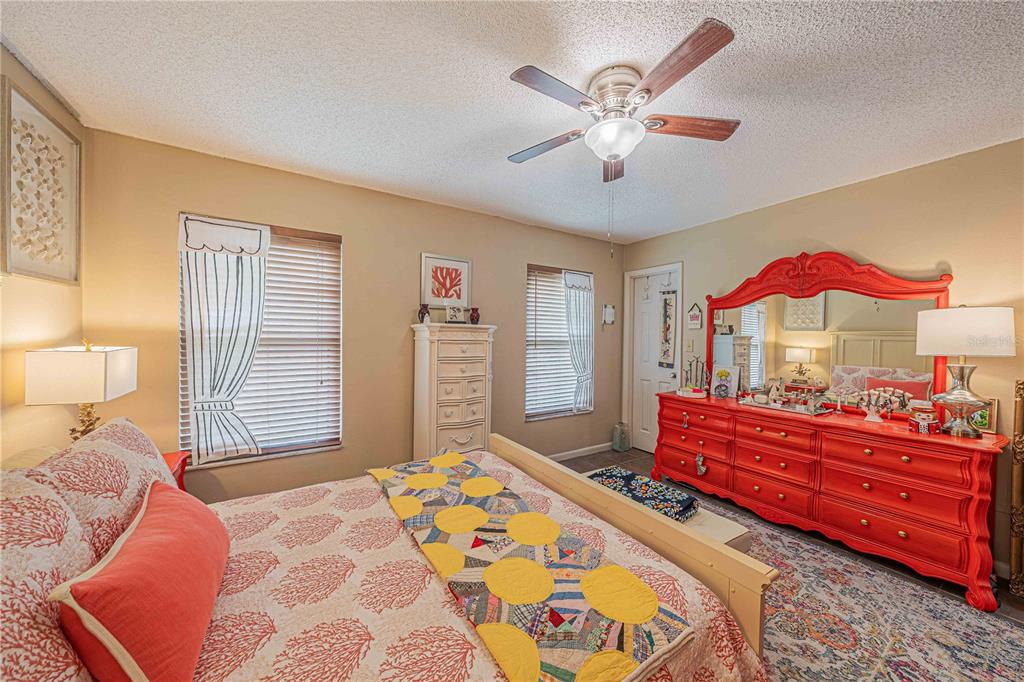 2418 Northeast 7th Street, Unit 6 Ocala, FL 34470 - Photo 18 of 33 a bedroom with a bed and a chandelier