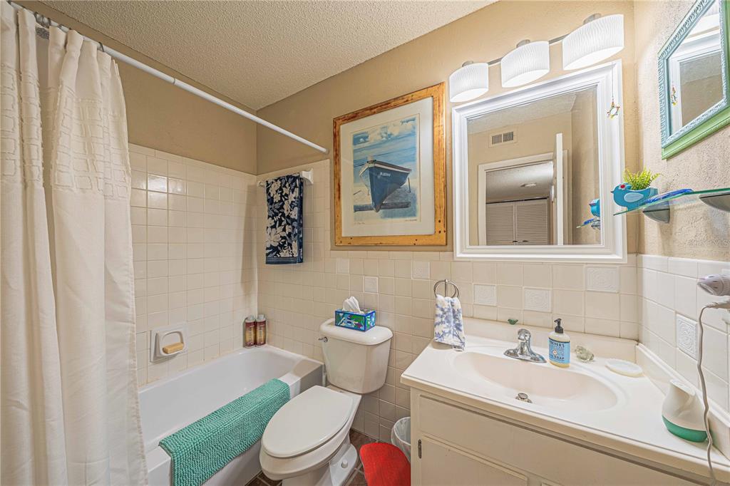 2418 Northeast 7th Street, Unit 6 Ocala, FL 34470 - Photo 19 of 39 a bathroom with a sink mirror vanity and toilet