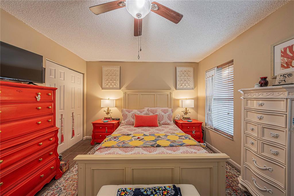 2418 Northeast 7th Street, Unit 6 Ocala, FL 34470 - Photo 20 of 33 a bedroom with a bed and flat screen tv