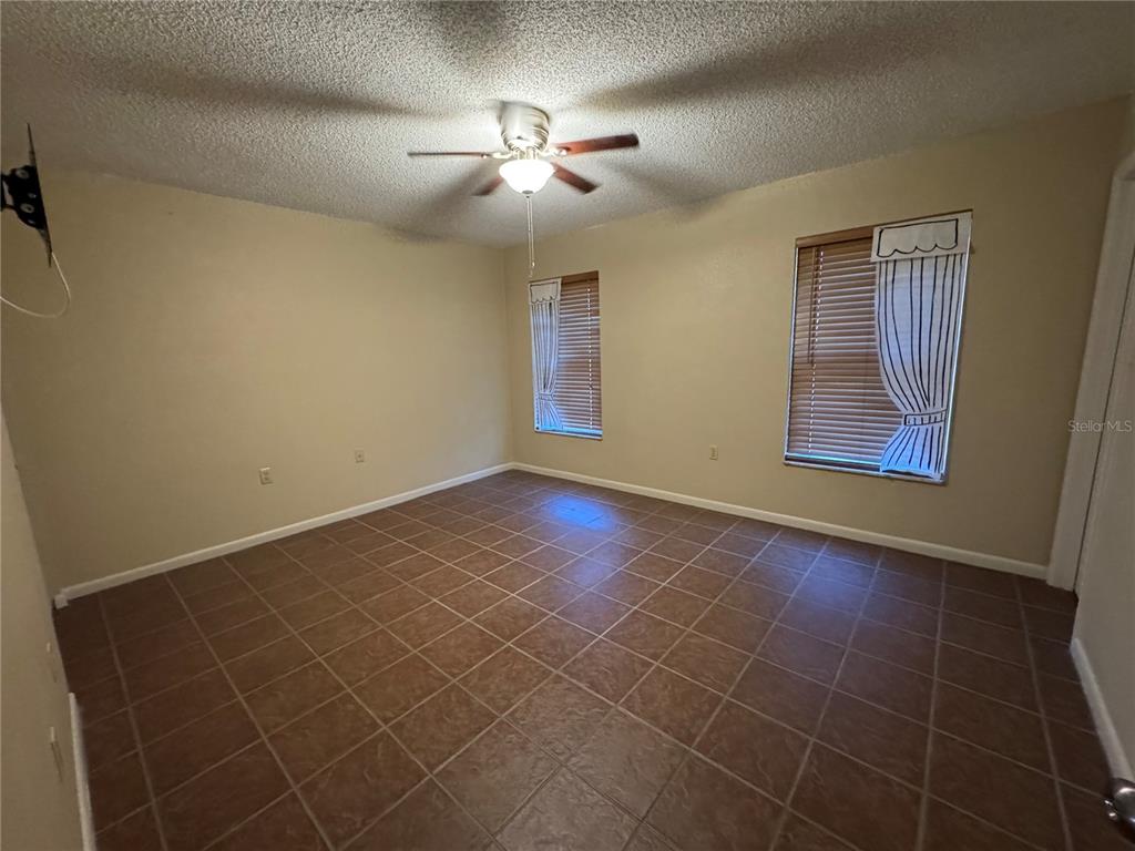 2418 Northeast 7th Street, Unit 6 Ocala, FL 34470 - Photo 2 of 39 a view of an empty room with a fan