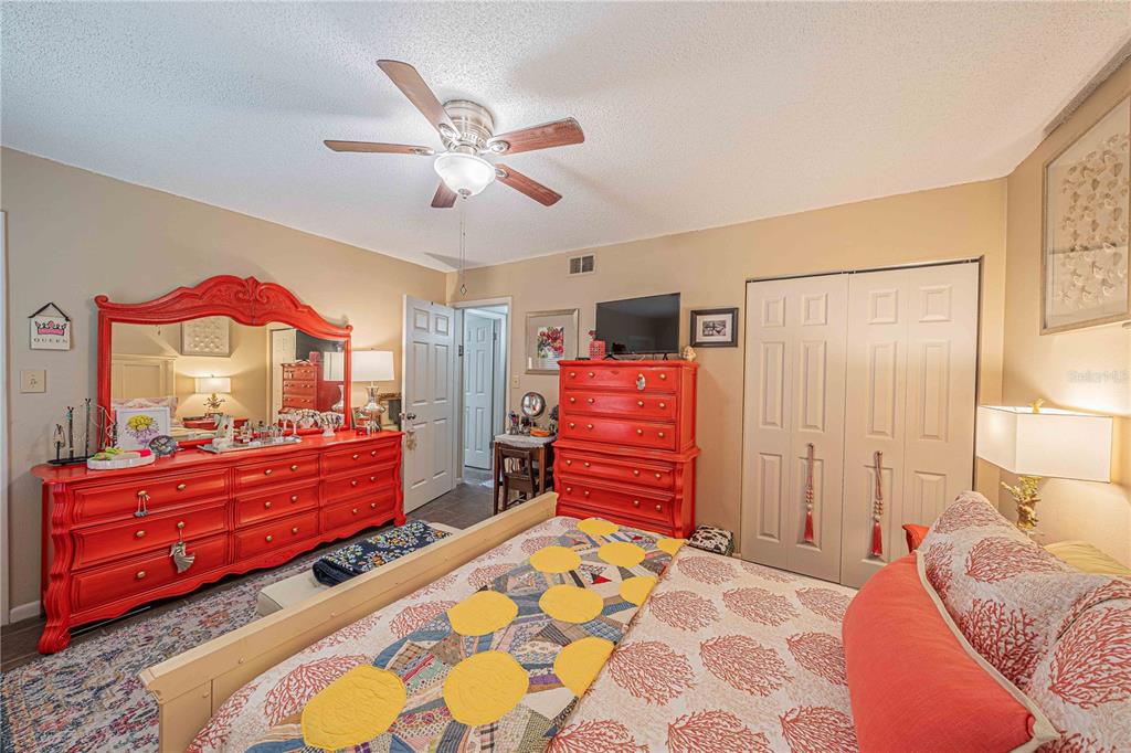 2418 Northeast 7th Street, Unit 6 Ocala, FL 34470 - Photo 24 of 39 a bedroom with a bed and a chandelier