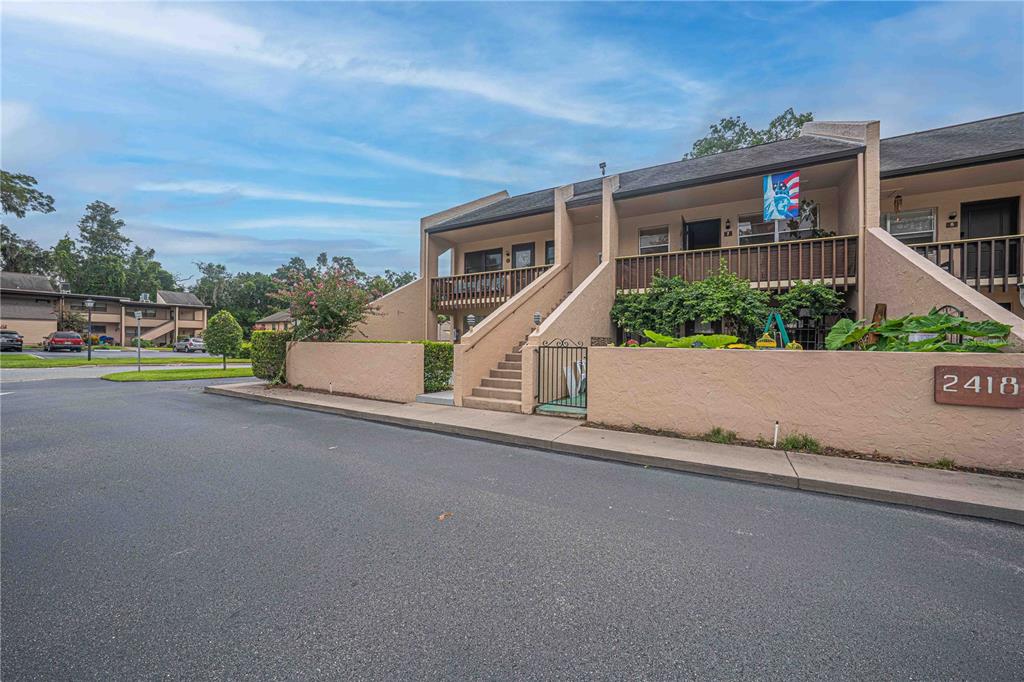 2418 Northeast 7th Street, Unit 6 Ocala, FL 34470 - Photo 24 of 33 front view of a house with a street