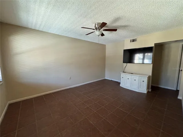 a view of a livingroom with a kitchen space and a window