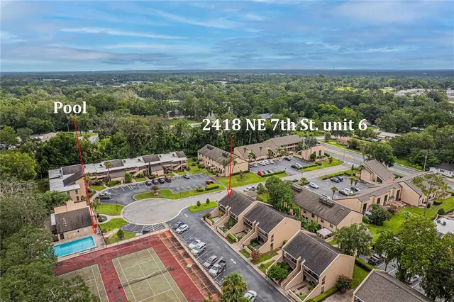 an aerial view of a house with garden space and ocean view