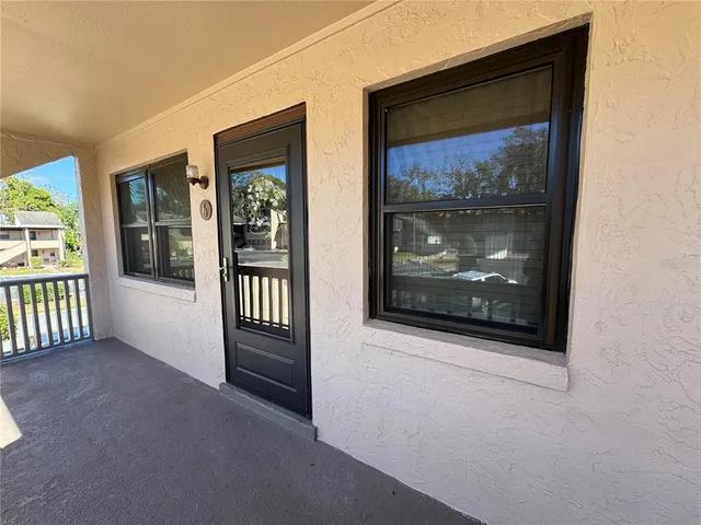 a view of a hallway with wooden floor and a fireplace