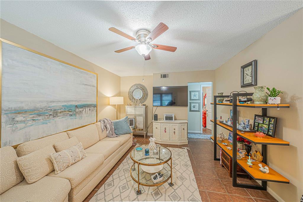 2418 Northeast 7th Street, Unit 6 Ocala, FL 34470 - Photo 5 of 33 a living room with furniture and a flat screen tv