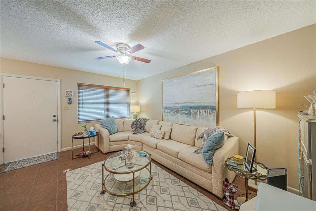 2418 Northeast 7th Street, Unit 6 Ocala, FL 34470 - Photo 9 of 39 a living room with furniture and a large window