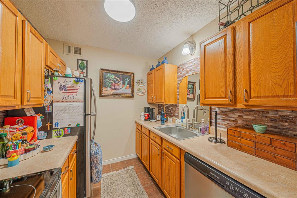 2418 Northeast 7th Street, Unit 6 Ocala, FL 34470 - Photo 9 of 33 a kitchen with stainless steel appliances a sink and a refrigerator