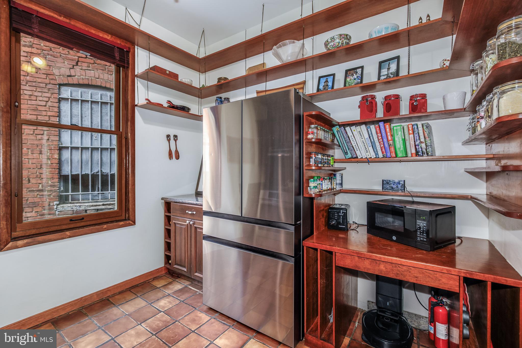 804 A Street Northeast Washington, DC 20002 - Photo 8 of 25 a kitchen with stainless steel appliances granite countertop a refrigerator a stove and a wooden cabinets