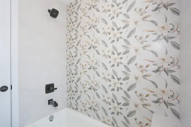 a bathroom with a bathtub and a shower