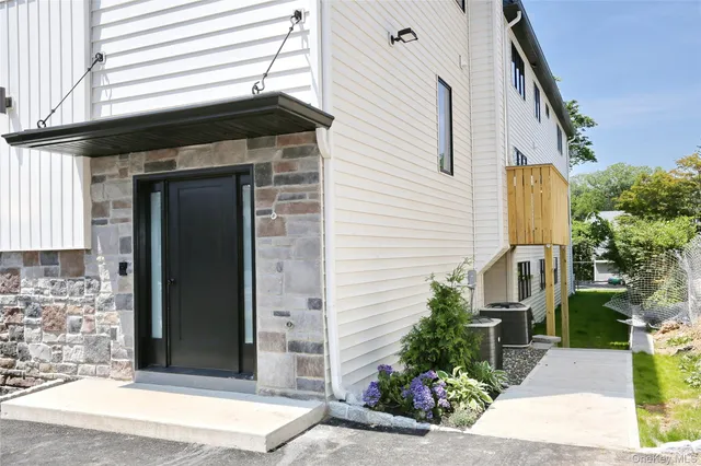 a view of a street with potted plants