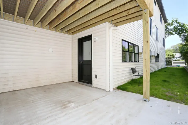 a view of a white house with a yard