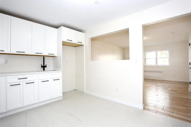 a kitchen with granite countertop white cabinets and sink