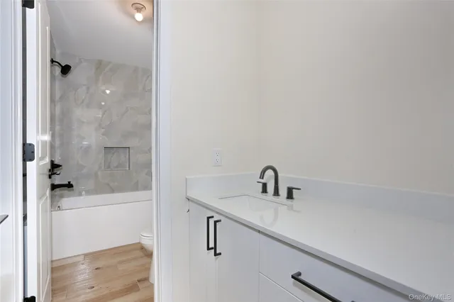 a bathroom with a sink a shower and a mirror