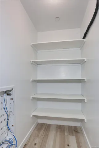 a view of walk in closet with empty racks