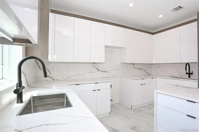 a view of a kitchen with sink and cabinets