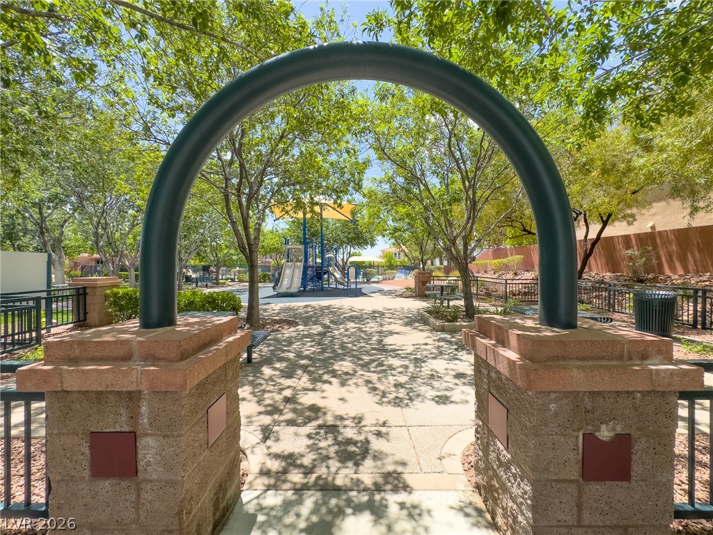 1333 Jamesbury Road Las Vegas, NV 89135 - Photo 42 of 43 Shady pathways lead to a community playground with slides and recreational equipment.