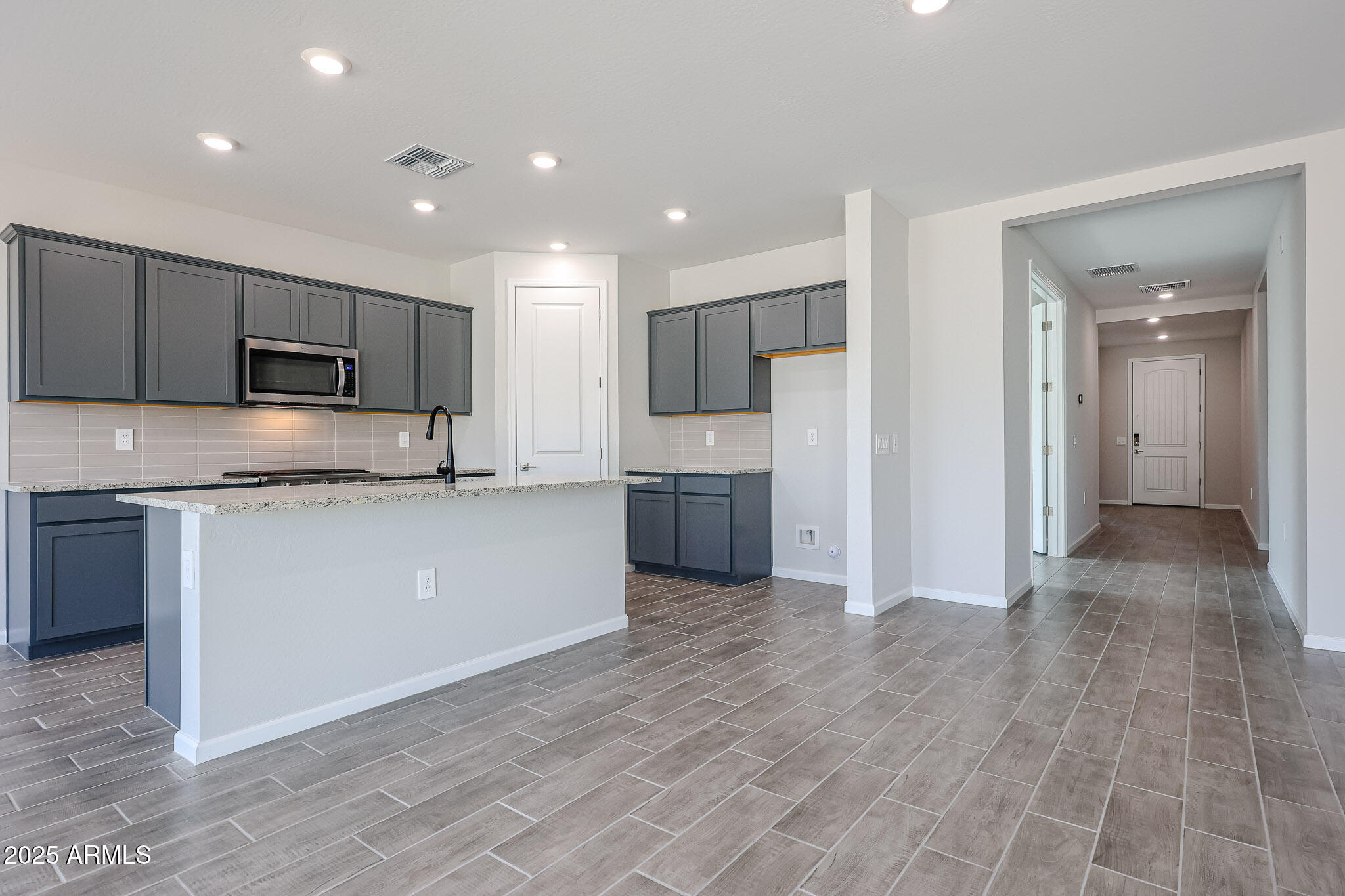17867 West Fulton Street Goodyear, AZ 85338 - Photo 13 of 40 a kitchen with stainless steel appliances granite countertop a refrigerator and a stove top oven