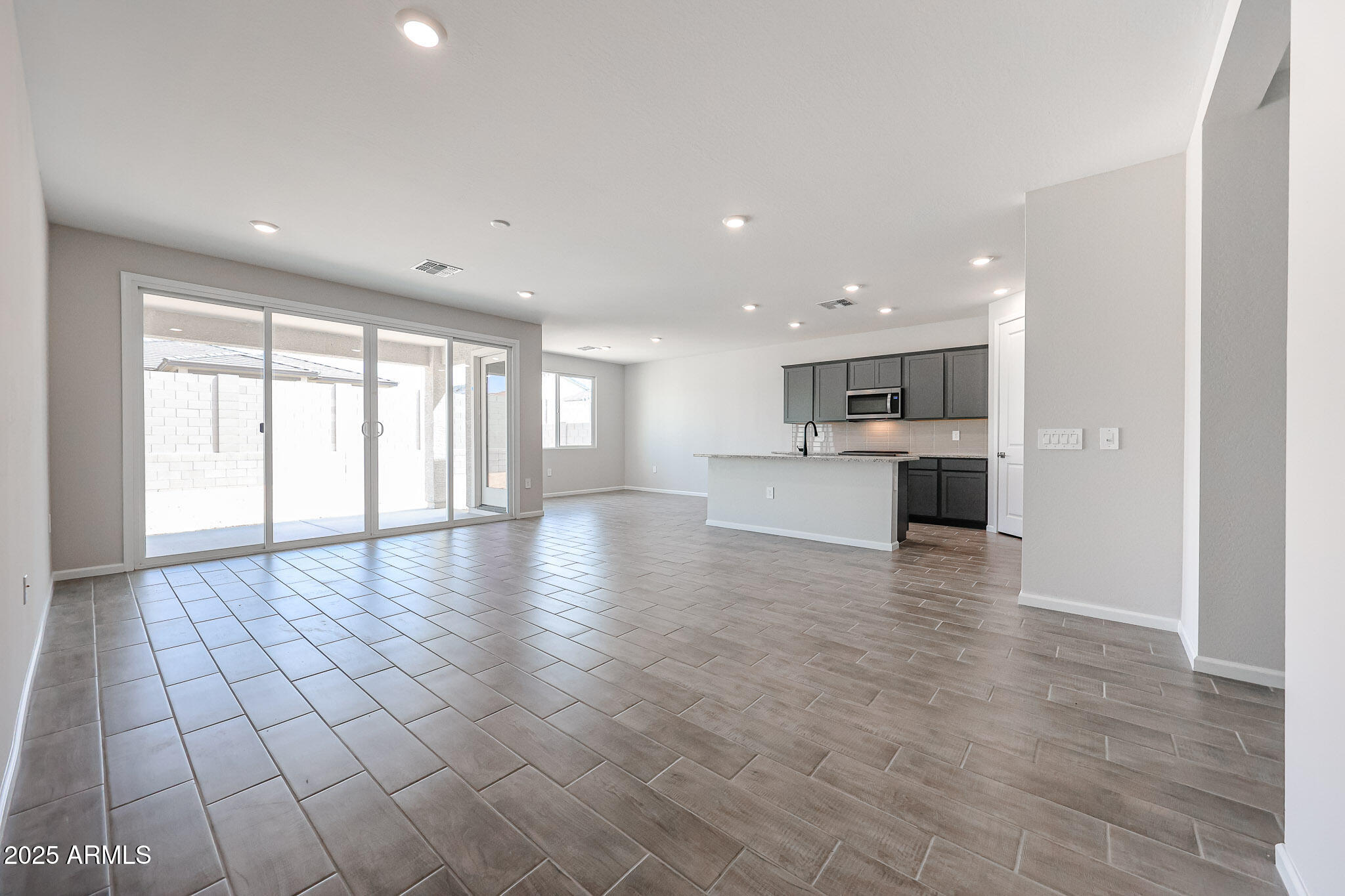 17867 West Fulton Street Goodyear, AZ 85338 - Photo 14 of 40 a view of an empty room with a window and wooden floor