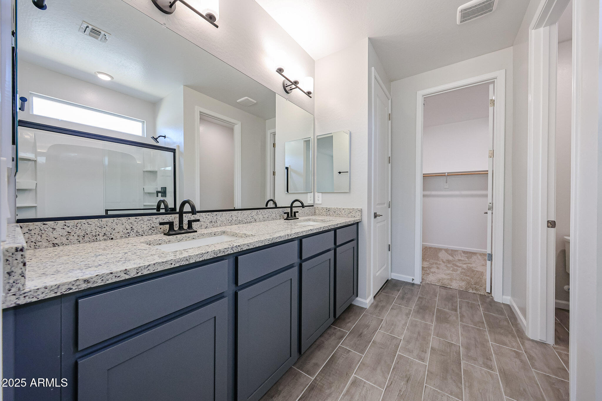 17867 West Fulton Street Goodyear, AZ 85338 - Photo 18 of 40 a bathroom with a double vanity sink and a mirror