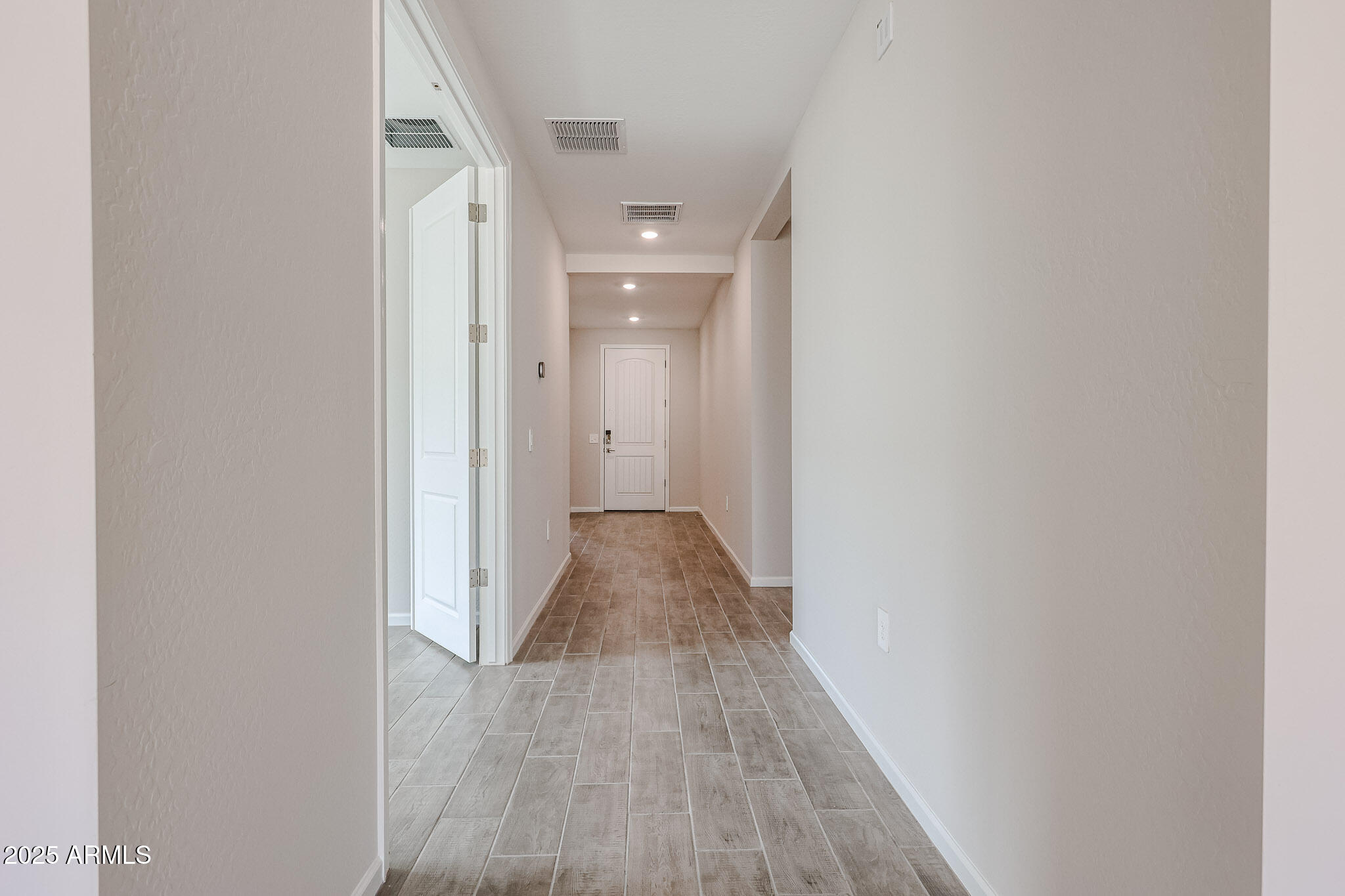 17867 West Fulton Street Goodyear, AZ 85338 - Photo 22 of 40 a view of a hallway with wooden floor