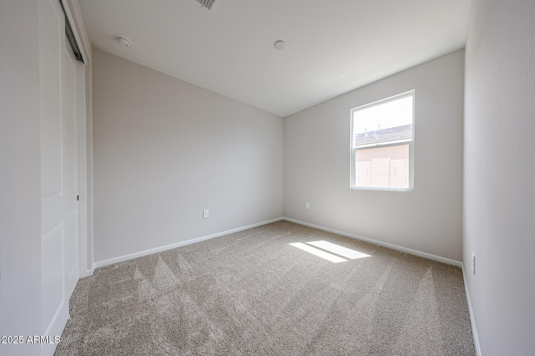17867 West Fulton Street Goodyear, AZ 85338 - Photo 33 of 40 an empty room with a window